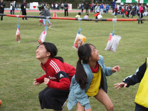 （写真）「パン食い競争」に参加する子供たち