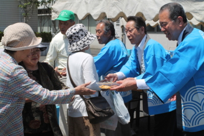 （写真）お餅を配る熊坂教育長、小野澤町長、鳥羽議会議長
